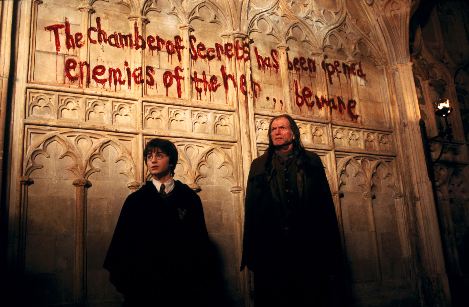 Harry and Filch by the bloodied wall