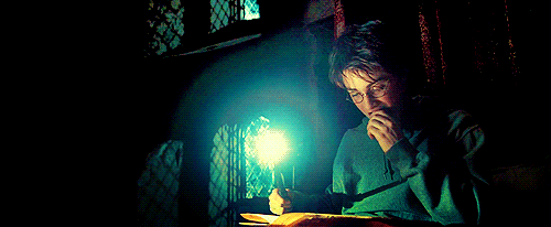Harry reads by wandlight